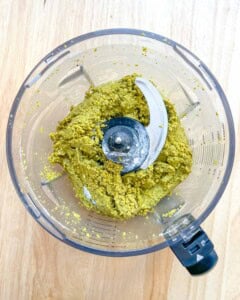 blended pistachio in a blender. half way blended.