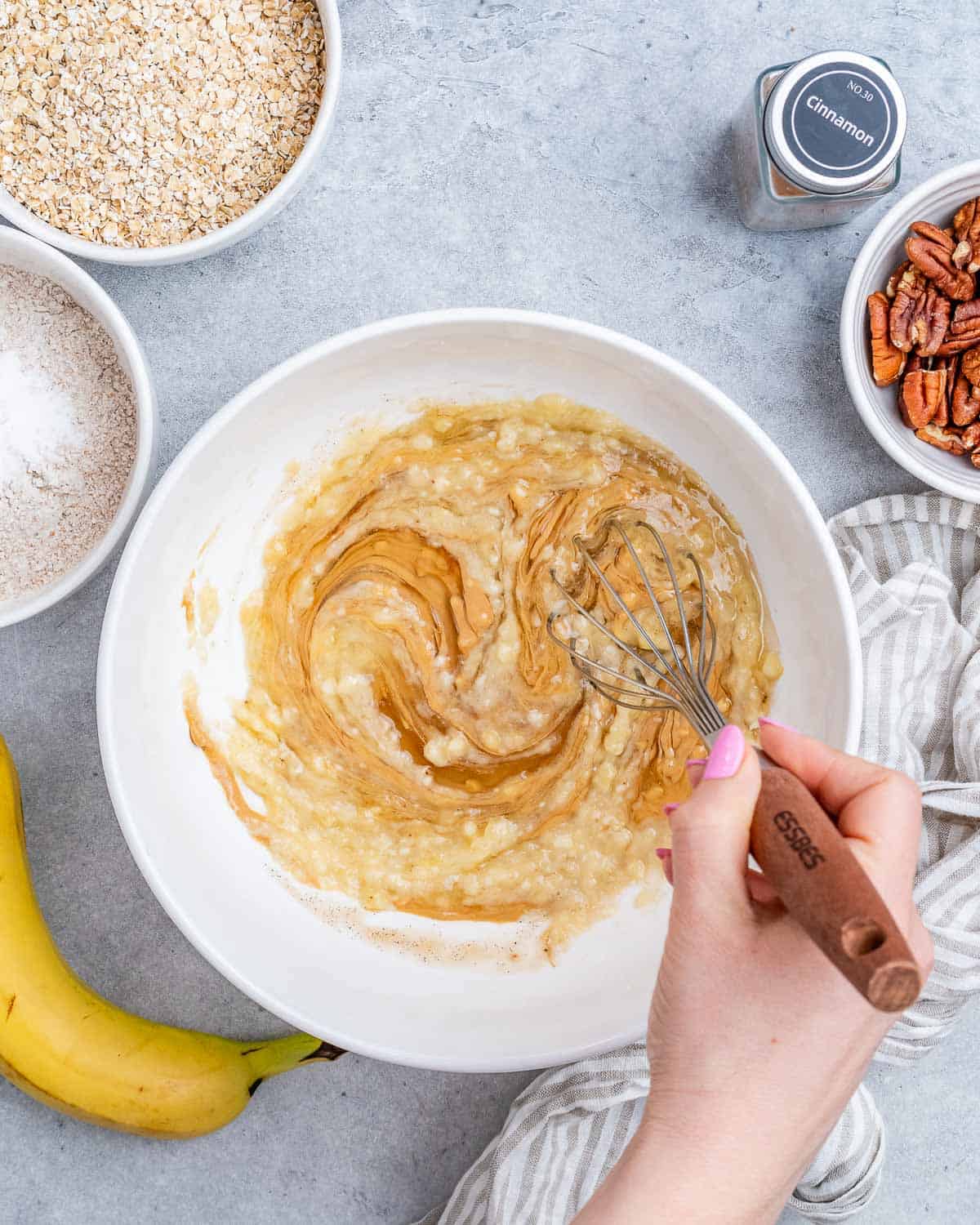 peanut butter added with mashed banana in a bowl.