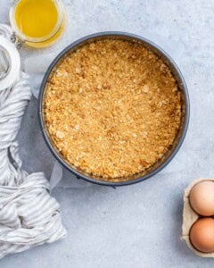 Graham cracker crust pressed into a springform pan.