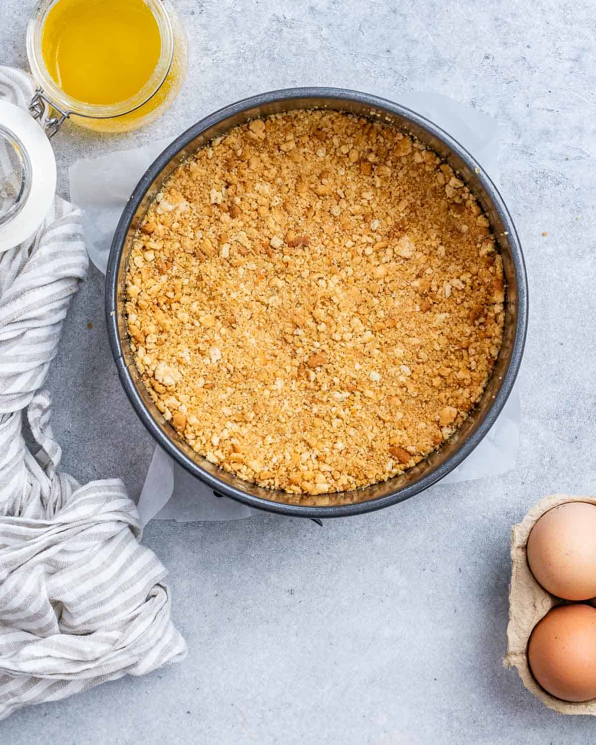 Graham cracker crust pressed into a springform pan.