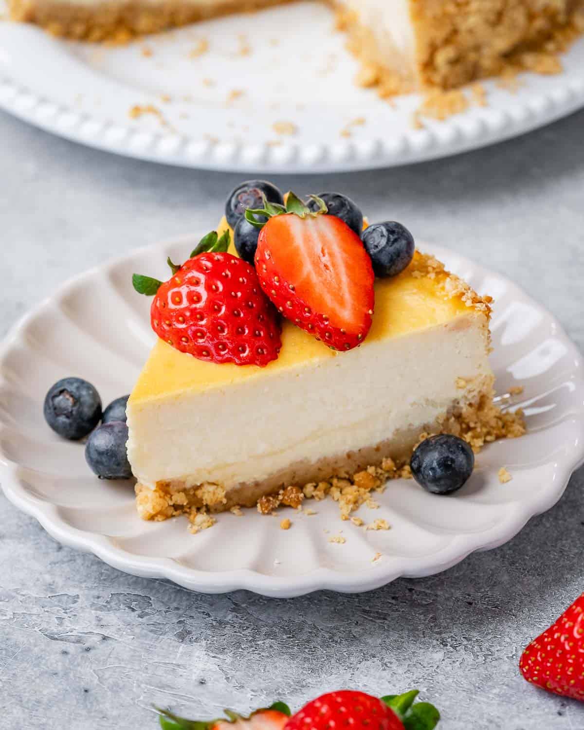 A slice of cottage cheese cheesecake served with mixed berries.