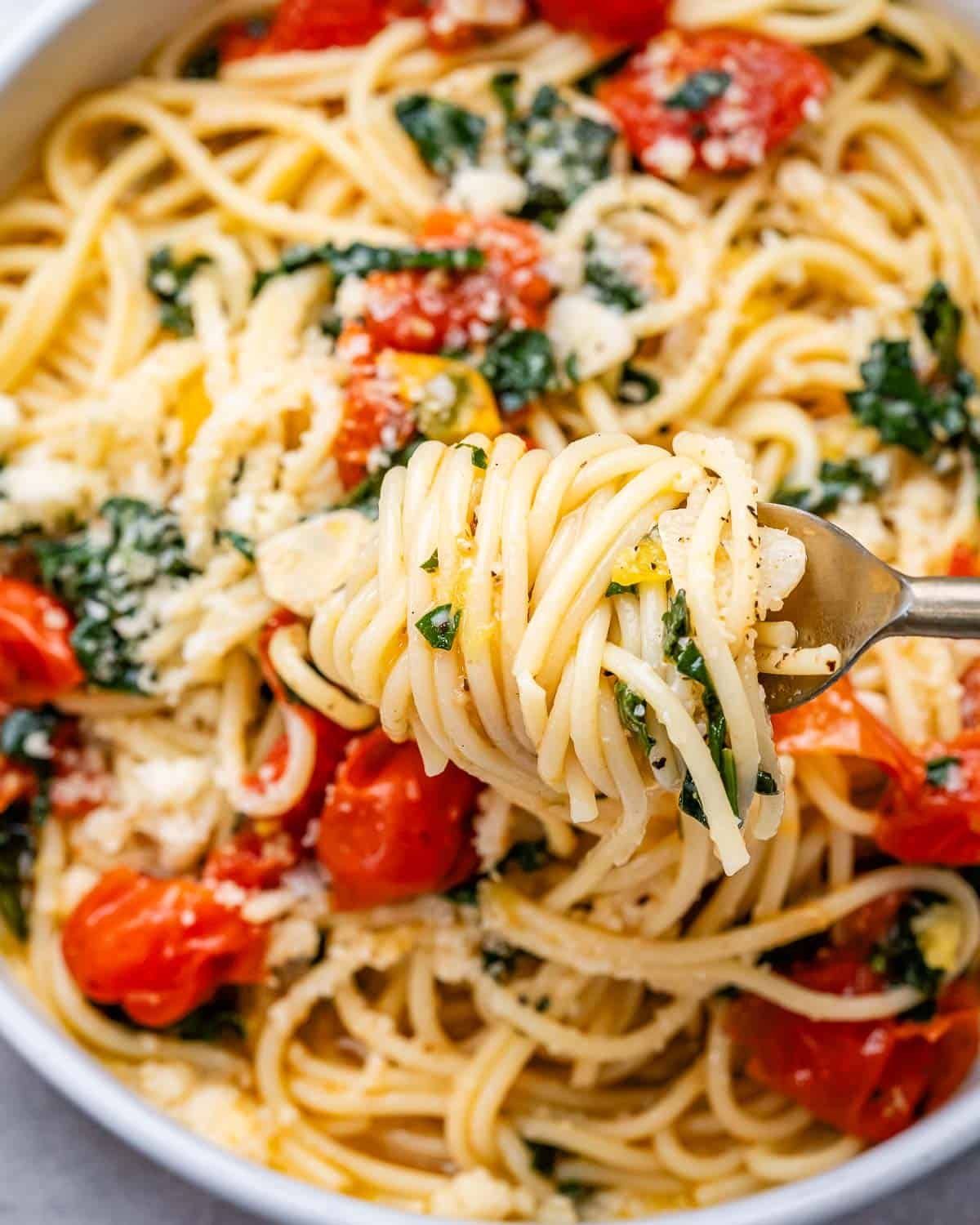 fork grabbing a portion of spaghetti from skillet.