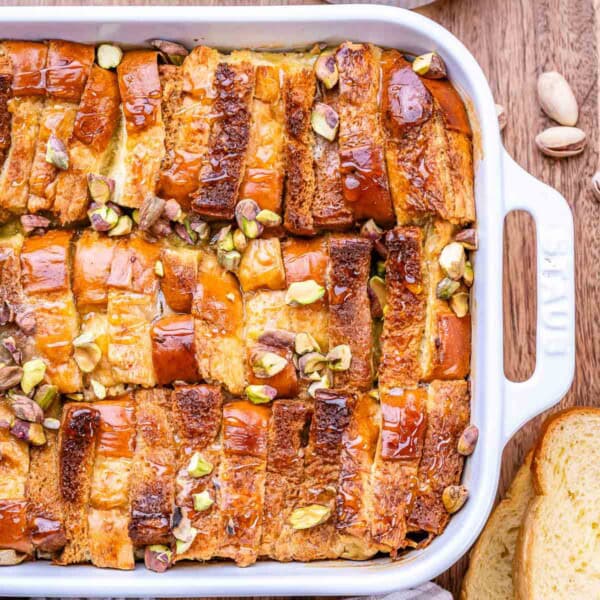French toast casserole in a dish, topped with chopped pistachios.