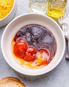 Sauce ingredients in a bowl on a countertop.