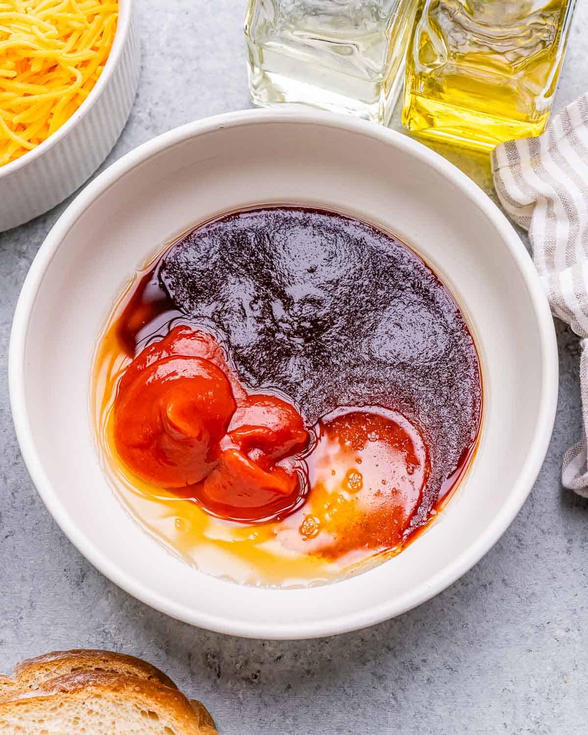 Sauce ingredients in a bowl on a countertop.