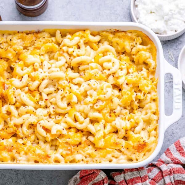 Close-up of a portion of mac and cheese being served from the baking dish.