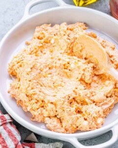Unbaked buffalo chicken dip mixture in a bowl, creamy and well-mixed before baking.