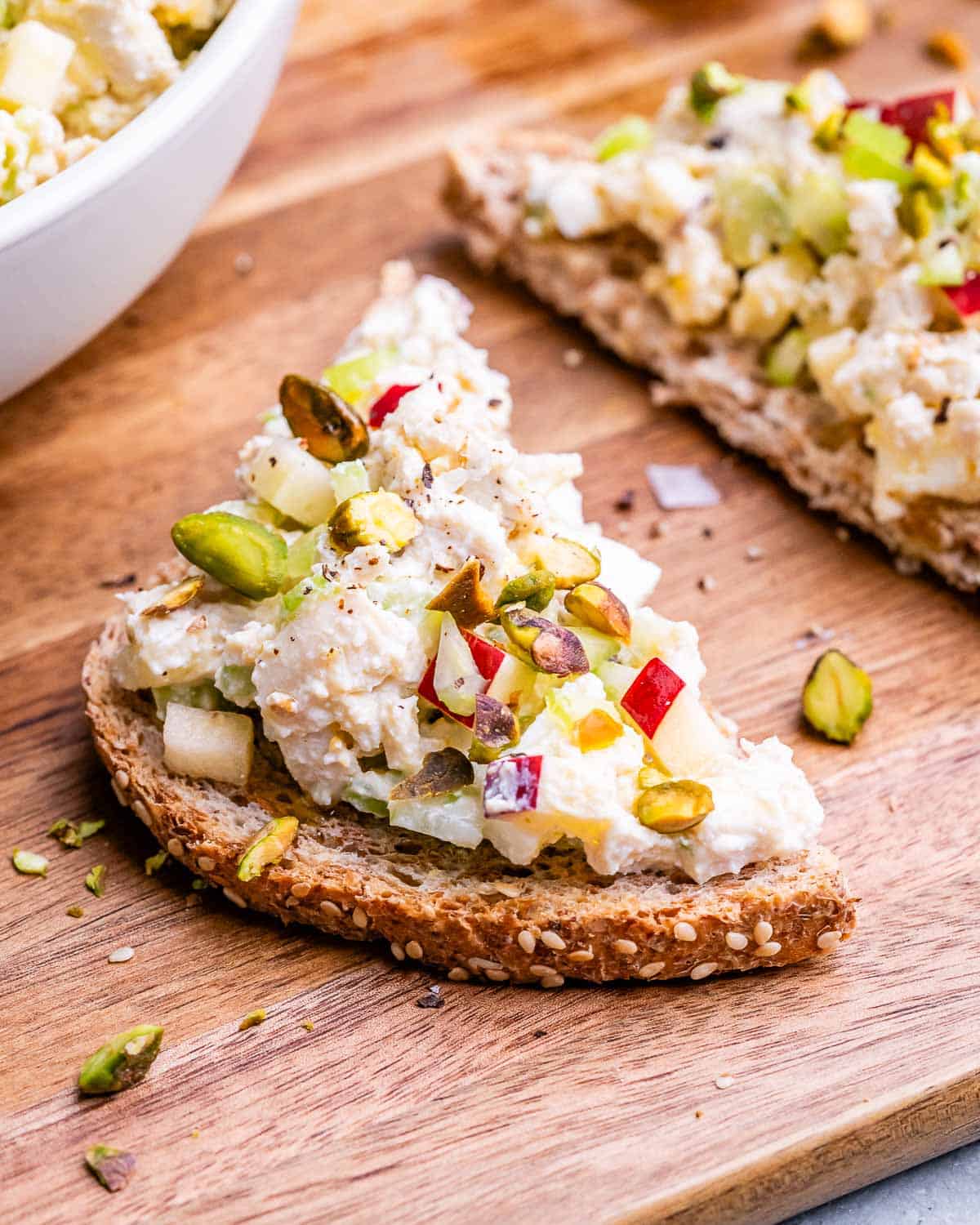 Two slices of bread topped with cottage cheese chicken salad.