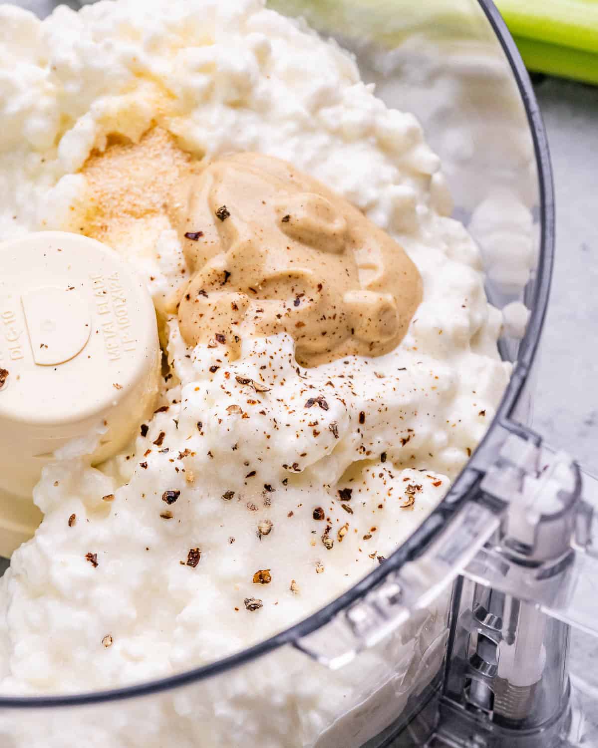 Ingredients in a food processor ready to be blended.