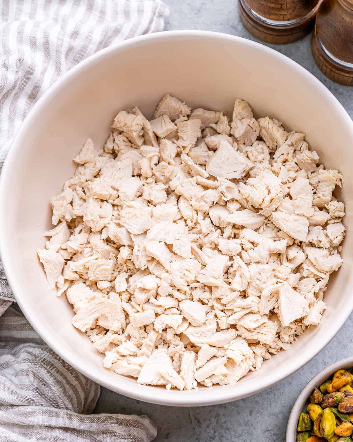 Shredded chicken in a white bowl.