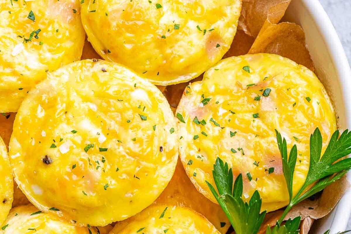 turkey cottage cheese egg bites in a white bowl with parsley
