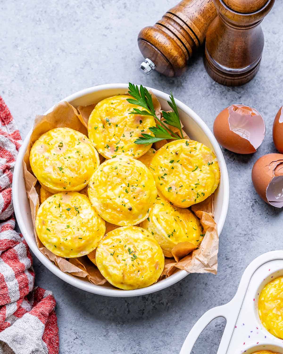 cottage cheese egg bites overhead in a white bowl with egg shells on the table