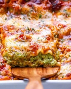 a slice of cottage cheese lasagna being lifted from baking dish