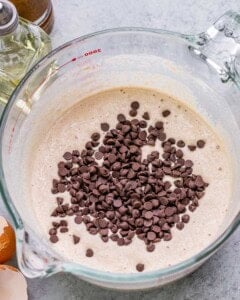 Mixing bowl with thick batter and mini chocolate chips folded in.