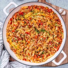 a skillet with tomato-based pasta made with ground turkey.