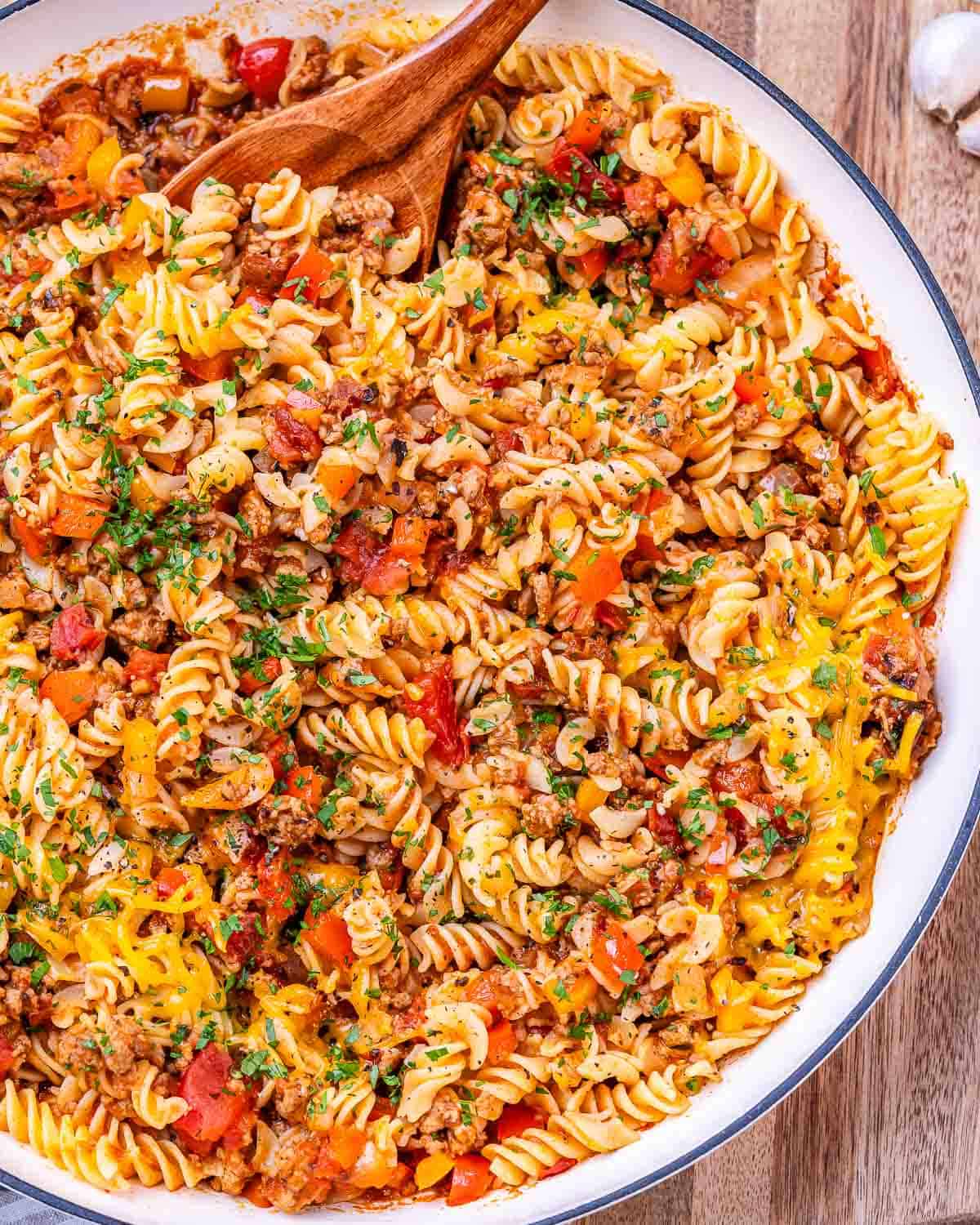 Another view of the finished skillet, showing the mix of pasta, turkey, peppers, and cheese with a golden, melty top.