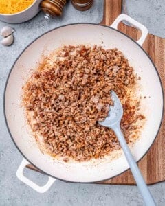 Ground turkey browning in a skillet.