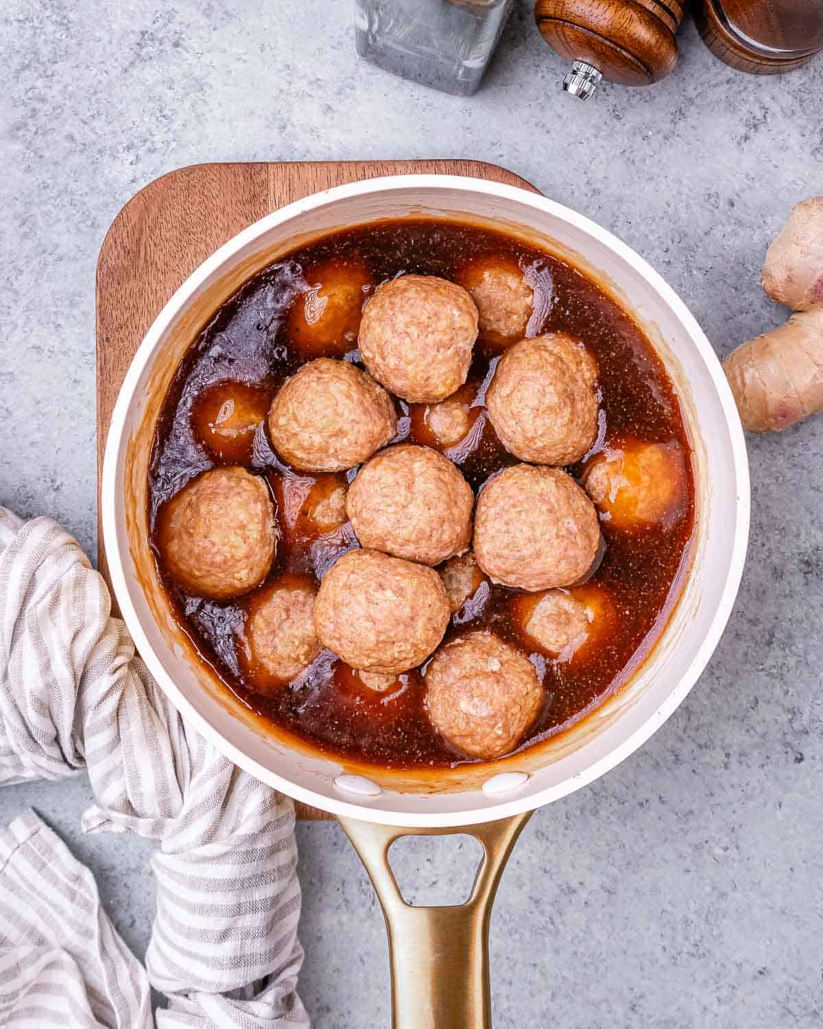 Meatballs in sauce in a pot.