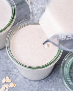 Pouring blended oats into a jar