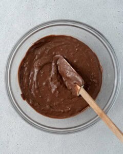 Bowl of chocolate batter with a spatula in it.