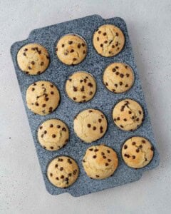 Twelve muffins cooling on a wire rack, spaced evenly and photographed from above.