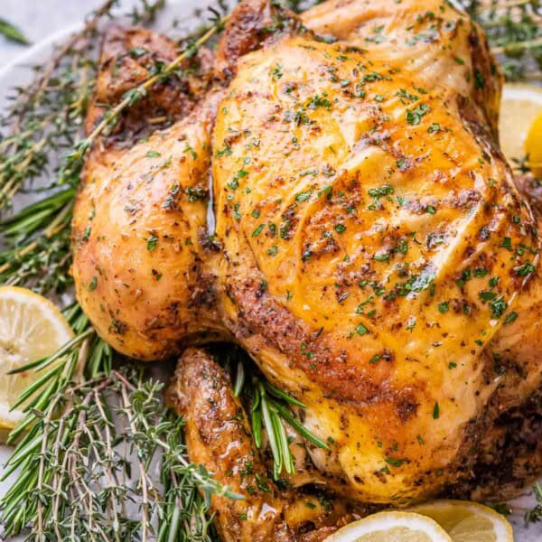 Baked chicken with herbs on a plate.