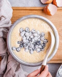 folding blueberries into bundt cake batter