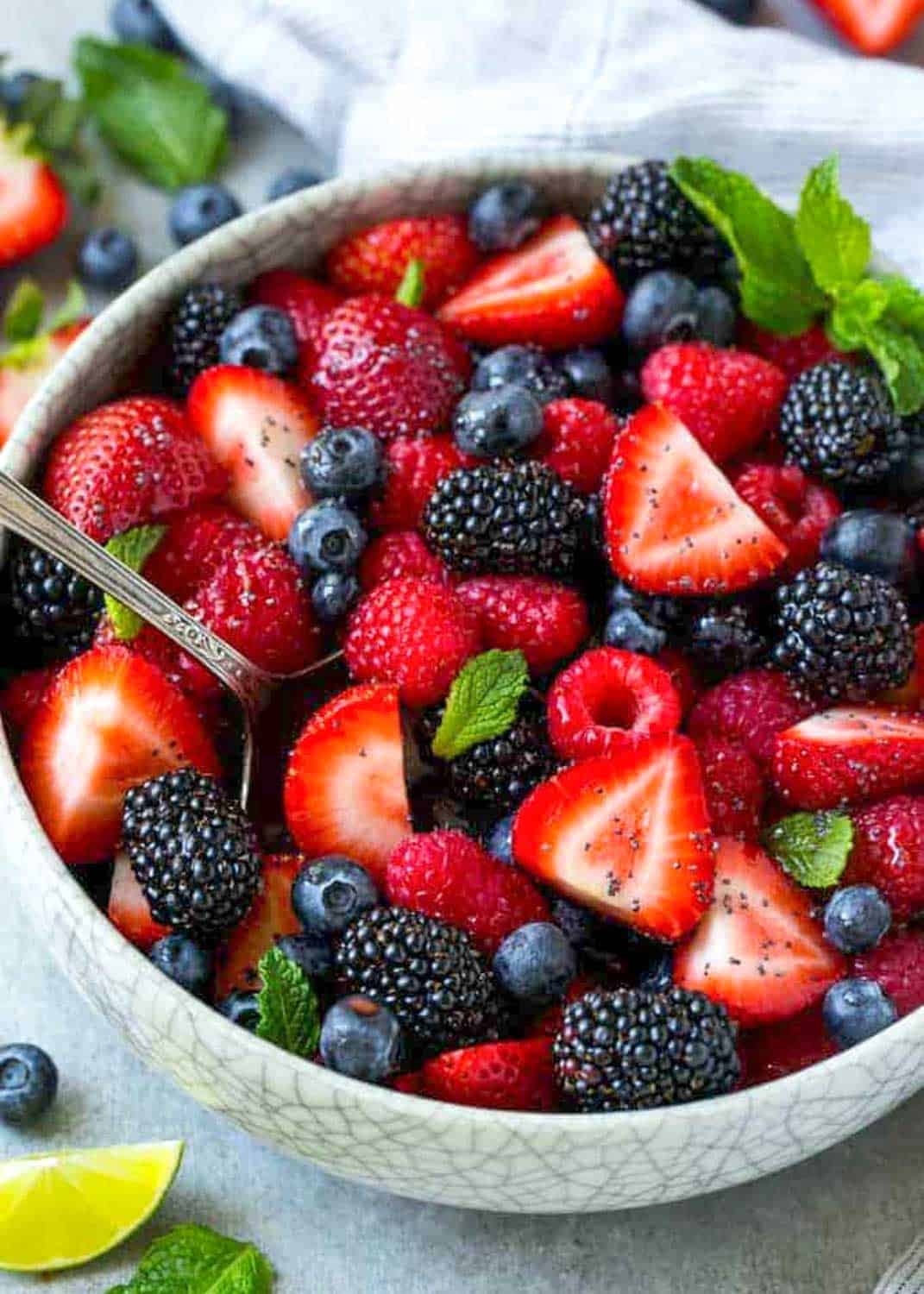 a round bowl with fresh mixed berries.