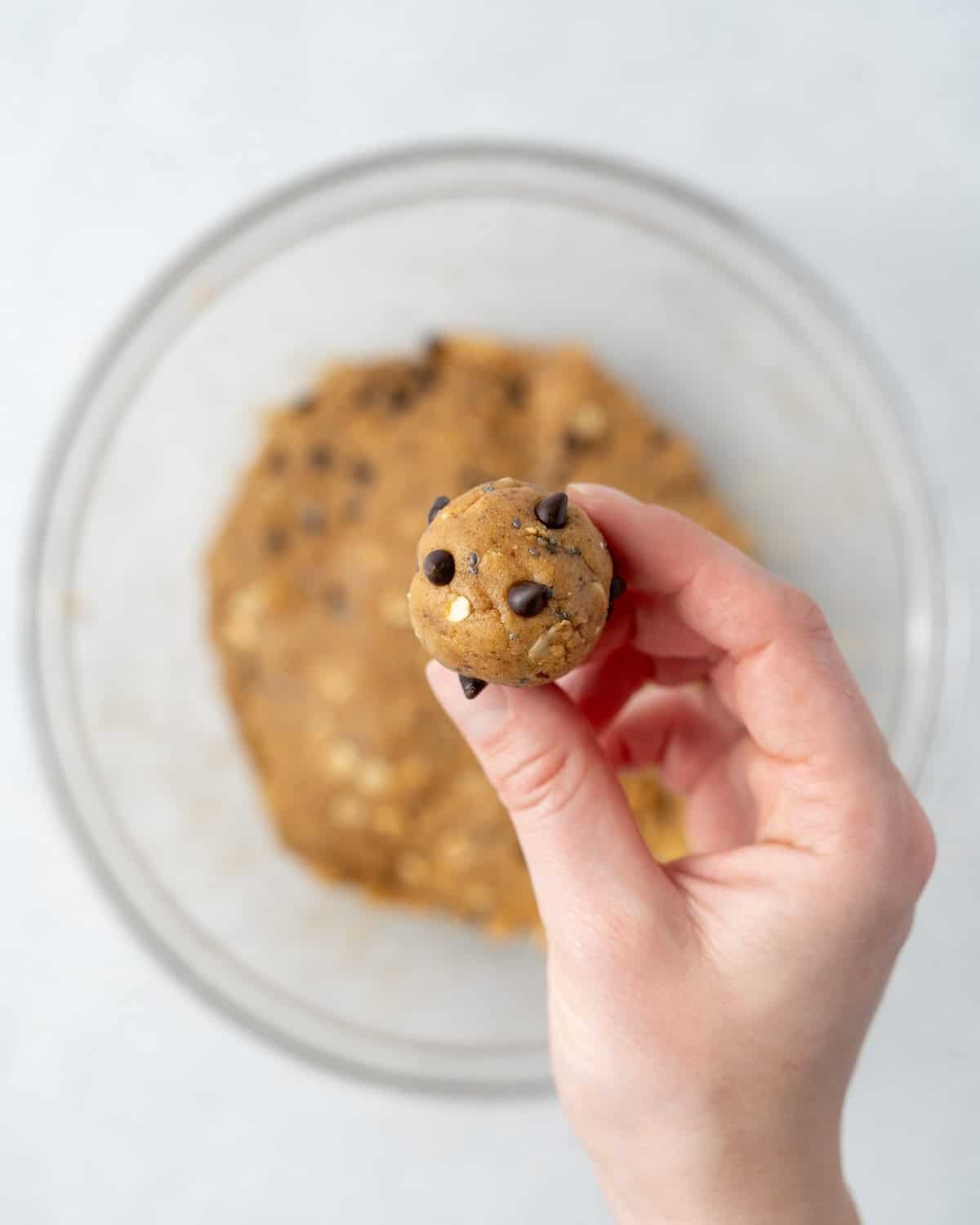 hand holding a single peanut butter snack ball.