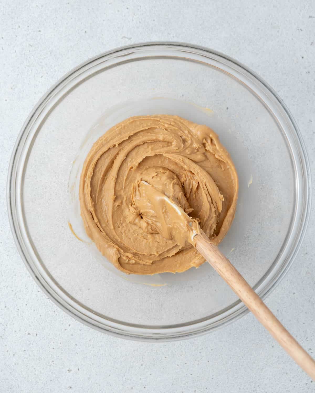 Peanut butter and honey are mixed in a bowl.