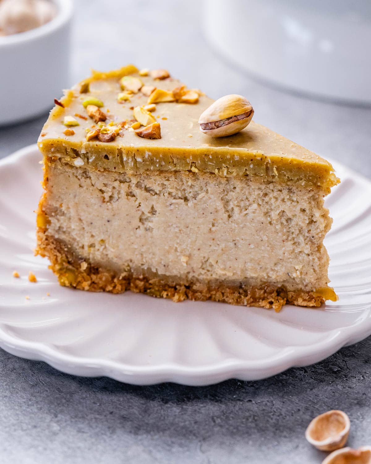 a slice of pistachio cheesecake on a white plate