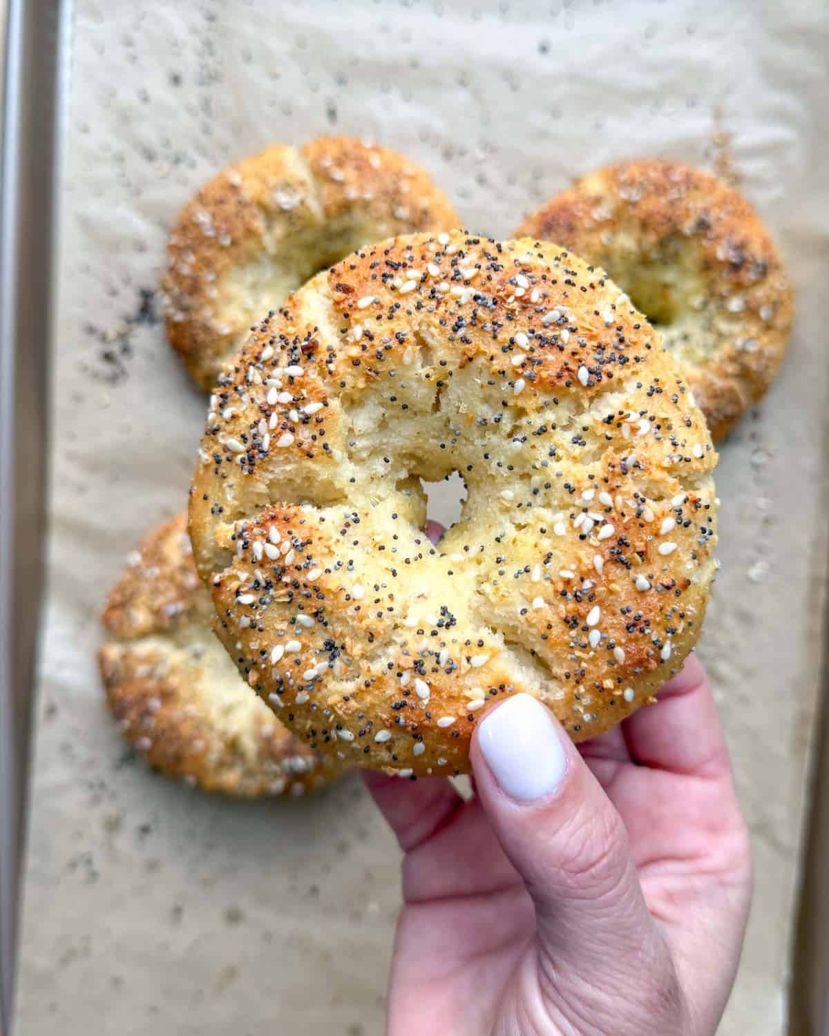 hand holding up a bagel.