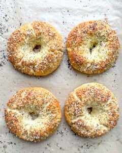 4 baked bagels on the sheet pan.