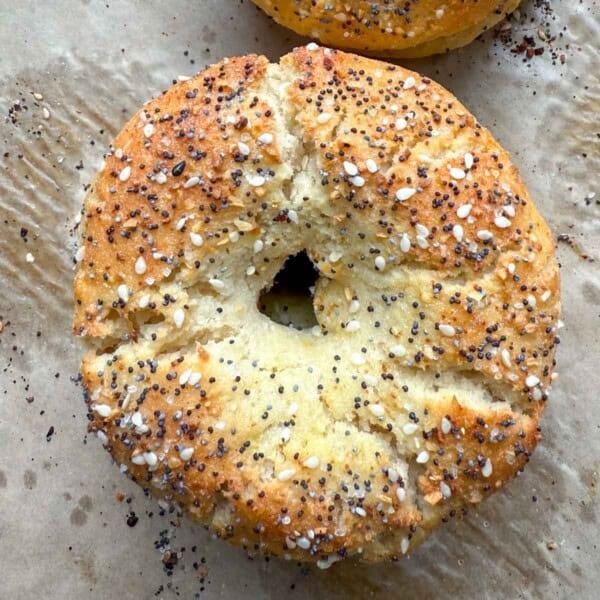 A single bagel on a sheet pan.