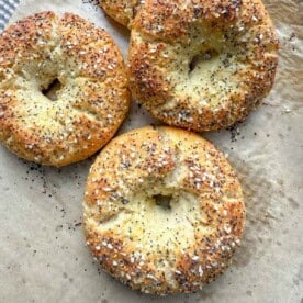 bagels on a sheet pan, topped with everything bagel seasoning.
