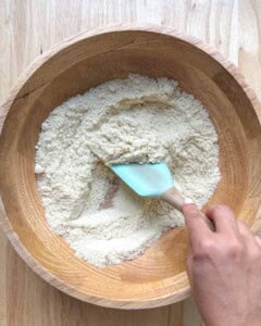 spatula mixing the almond flour in a bowl.