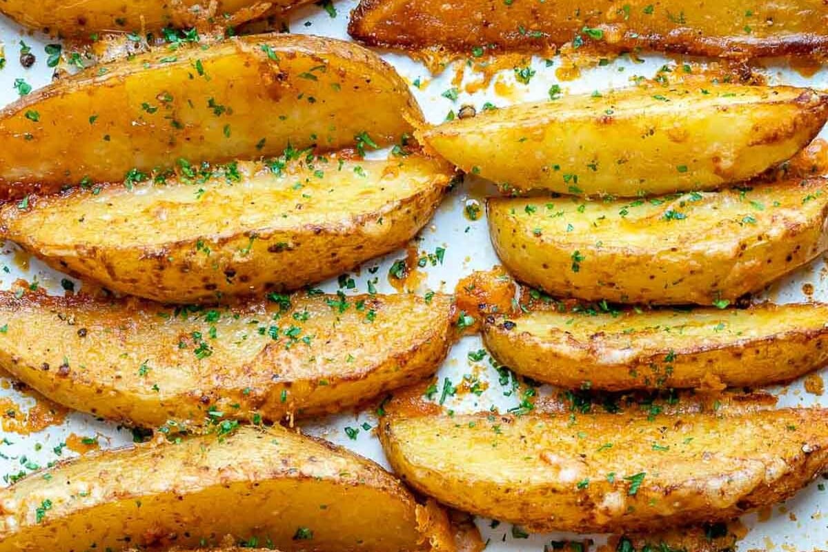 potato wedges laid out and baked on a sheetpan.