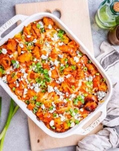 Buffalo chicken and potatoes in a casserole dish.
