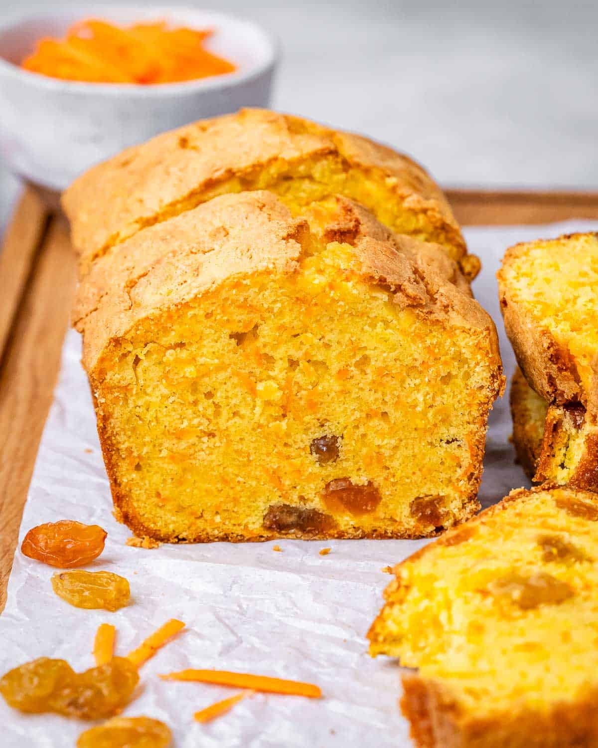 Close-up of sliced carrot cake loaf sliced, showing its golden color and moist interior.