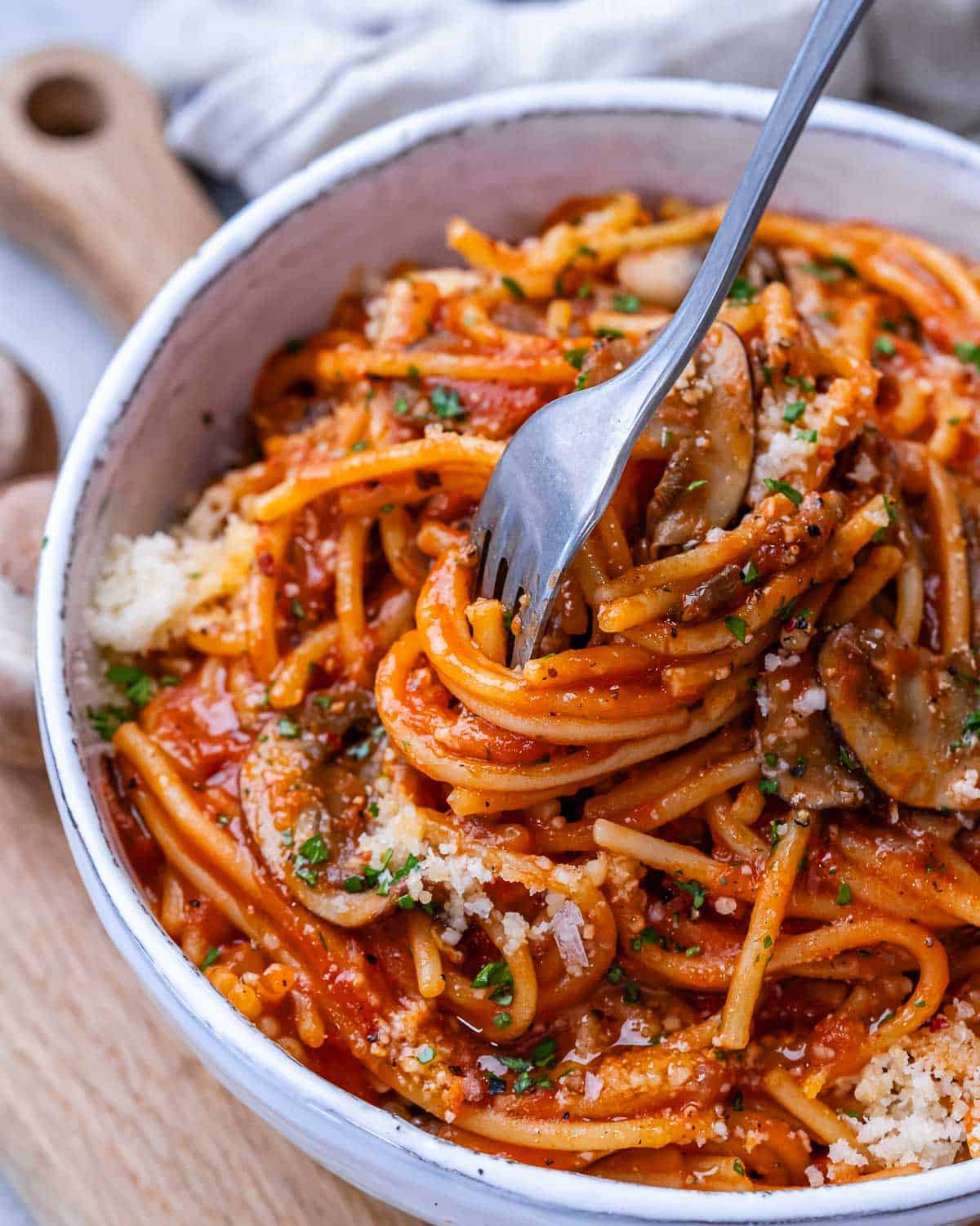 A fork twirling in a white bowl of Instant Pot spaghetti