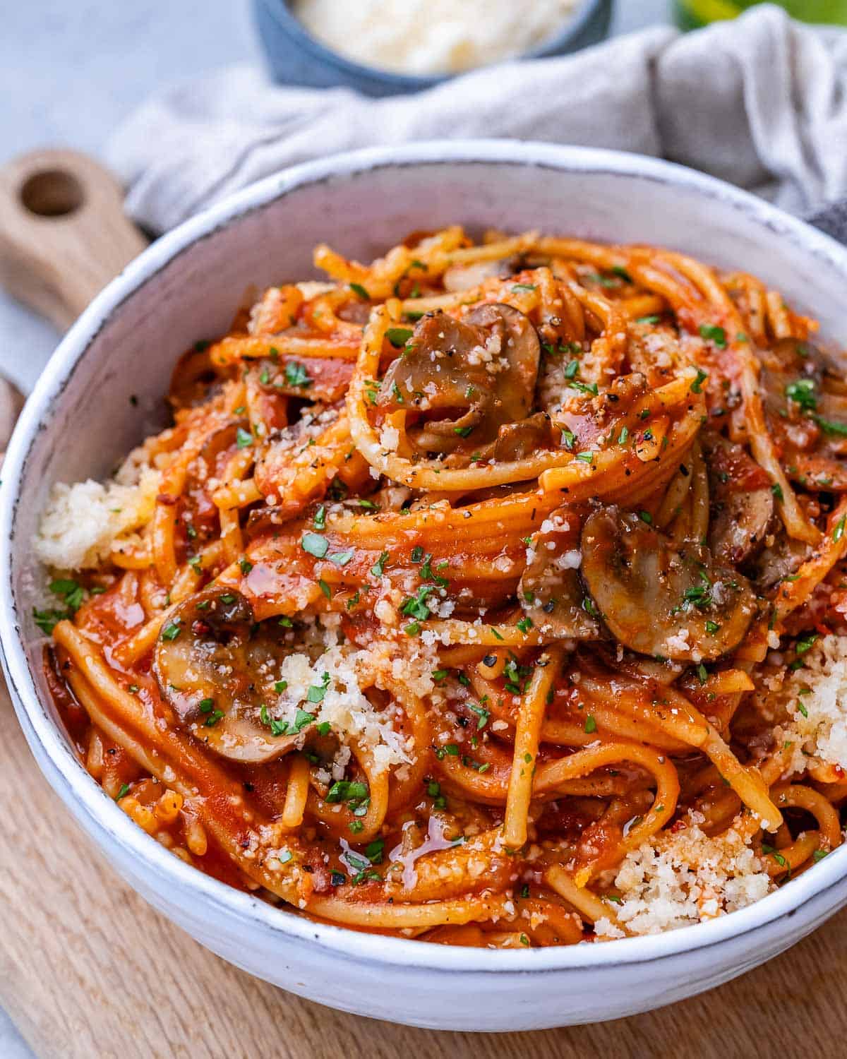 A white bowl with Instant Pot Spaghetti garnished with Parmesan cheese