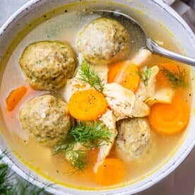 meatball soup with carrots in a bowl.