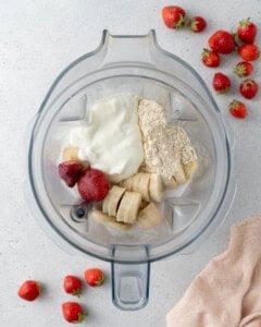 ingredients for smoothie added to a blender.