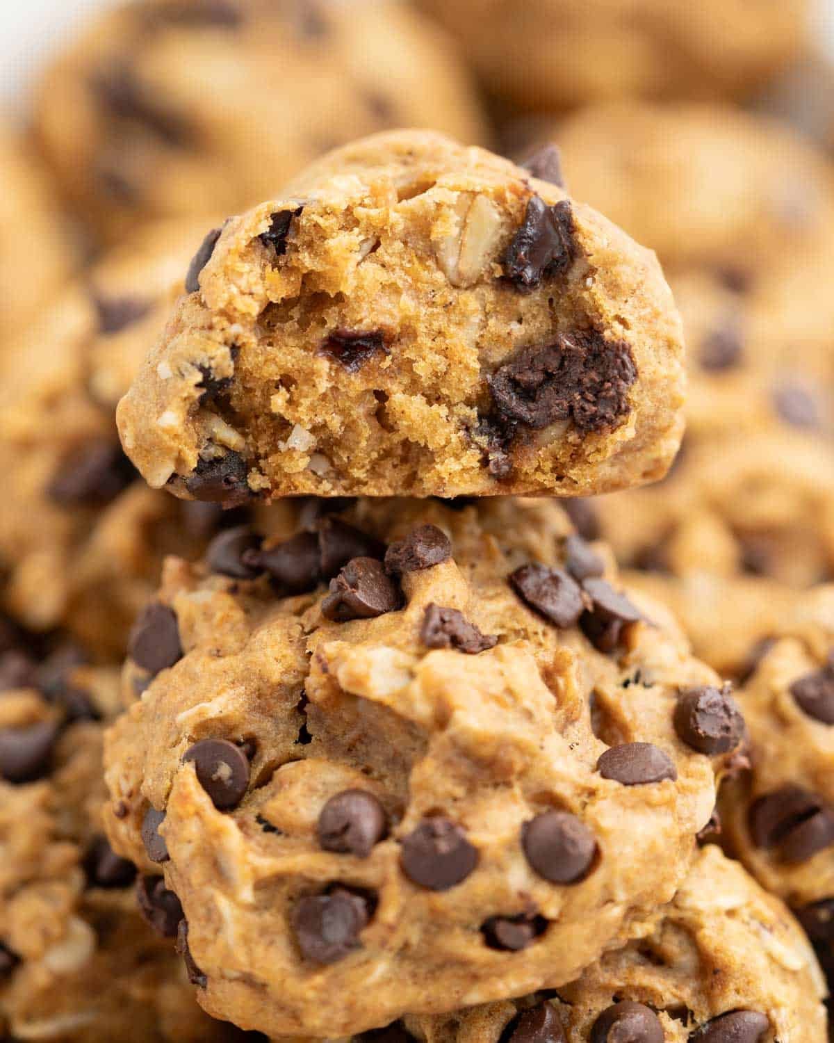 cookies stacked over each other and one on the top with a bite taken off it.