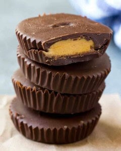 peanut butter cups stacked over each other on a board.