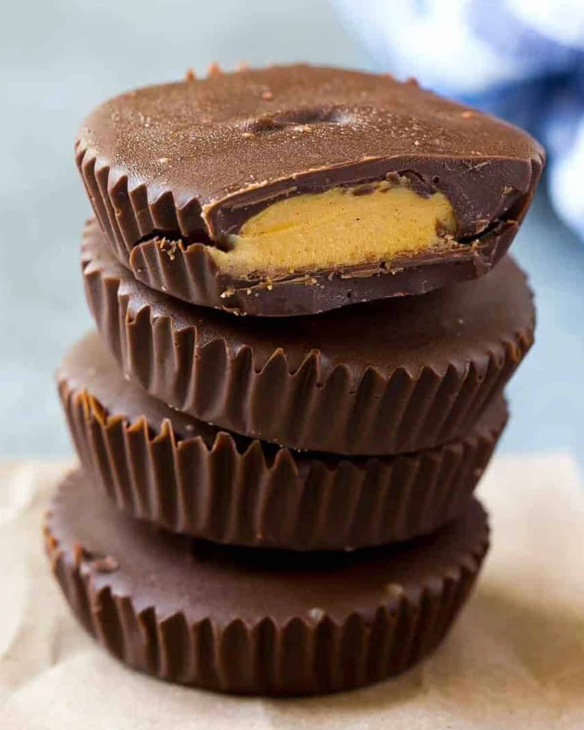 peanut butter cups stacked over each other on a board.