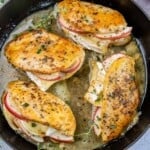 4 chicken breast in a pan stuffed with apple and brie cheese.