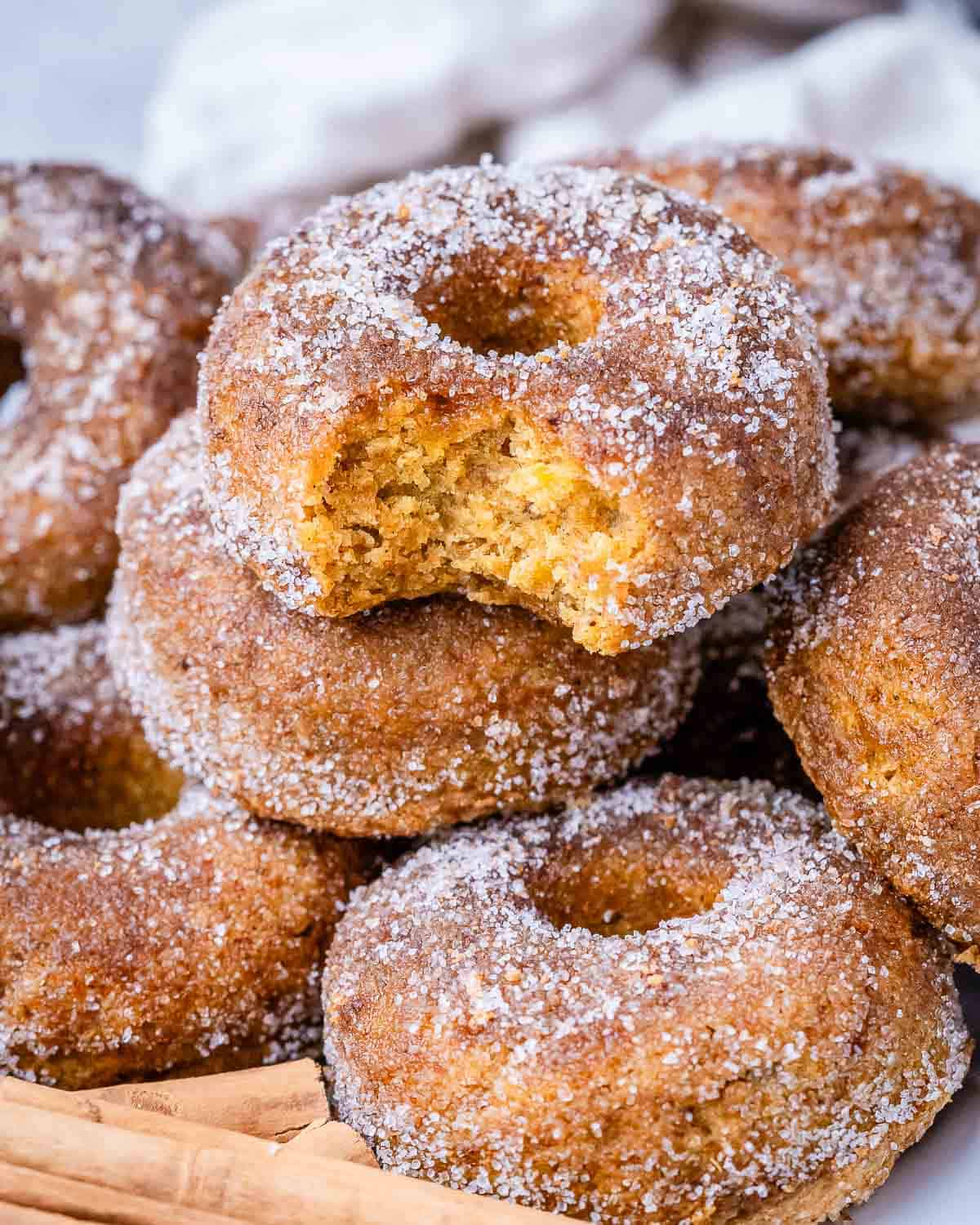 donuts stacked over each other on a plate.
