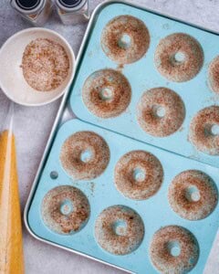cinnamon sugar coating in the donut mold cavity.