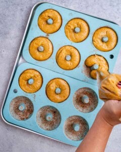 piping the donut batter into the donut silicone mold.